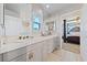 Bright bathroom with double sinks, and a view into a bedroom at 8904 Saint Pierre Dr, Las Vegas, NV 89134