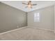 Neutral bedroom with a ceiling fan, carpet, and a window with plantation shutters at 234 Polaris Ridge Ave, Henderson, NV 89011