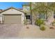 Two story house with a two-car garage and well-maintained front yard at 234 Polaris Ridge Ave, Henderson, NV 89011