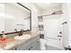 Bathroom with granite countertop, gray vanity, and shower/tub combo at 49 Vista Outlook St, Henderson, NV 89011