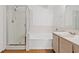 Well-lit bathroom showcasing a glass-enclosed shower, tub, and vanity at 7814 Ravenhollow Ln, Las Vegas, NV 89145