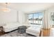 Bright living room with a white leather couch, hardwood floors and access to a balcony at 322 Karen Ave # 206, Las Vegas, NV 89109