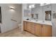 Double vanity bathroom with light wood cabinets and tile floors at 50 Aura De Blanco St # 17101, Henderson, NV 89074