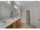 Bright bathroom with double sinks, shower/tub combo, and patterned curtain at 50 Aura De Blanco St # 17101, Henderson, NV 89074