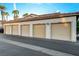 Four-car garage with beige doors and ample parking at 50 Aura De Blanco St # 17101, Henderson, NV 89074