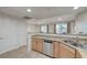 Updated kitchen featuring stainless steel dishwasher and granite counters at 50 Aura De Blanco St # 17101, Henderson, NV 89074