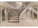 A curving basement staircase with carpeted steps and decorative iron railing at 8 Rue Mediterra Dr, Henderson, NV 89011