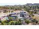 Breathtaking aerial view of a lavish three-story home boasting a terracotta roof, refreshing pool, and lush landscaping at 8 Rue Mediterra Dr, Henderson, NV 89011