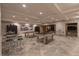Large entertainment area with pool tables, bar stools, and a view to the outside swimming pool at 8 Rue Mediterra Dr, Henderson, NV 89011