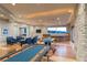 Spacious game room with poker and billiards tables, wet bar, and comfortable seating at 8 Rue Mediterra Dr, Henderson, NV 89011