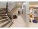 Elegant hallway featuring a spiral staircase, stone accent wall, and access to the bedroom at 8 Rue Mediterra Dr, Henderson, NV 89011