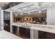 A bright, open kitchen with sleek countertops and stainless steel appliances overlooks a cozy living space at 8 Rue Mediterra Dr, Henderson, NV 89011