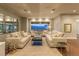 Bright living room featuring neutral décor, hardwood flooring, and a large window, offering serene mountain views at 8 Rue Mediterra Dr, Henderson, NV 89011