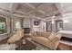 Cozy main bedroom with a coffered ceiling, a fireplace, and a view of the backyard at 8 Rue Mediterra Dr, Henderson, NV 89011