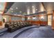Home theater with tiered seating, projector screen, and custom wood trim for an amazing viewing experience at 8 Rue Mediterra Dr, Henderson, NV 89011