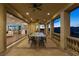 Covered outdoor dining area with mountain views and an open doorway to the indoor living area at 8 Rue Mediterra Dr, Henderson, NV 89011