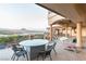 A covered patio offering outdoor seating, entertainment, and scenic views of the lake and mountains at 8 Rue Mediterra Dr, Henderson, NV 89011