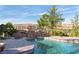 Backyard pool featuring mature landscaping, surrounding views, and a stone bridge at 8 Rue Mediterra Dr, Henderson, NV 89011