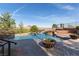 Luxury backyard pool featuring an elevated spa, desert views, and an expansive pool deck at 8 Rue Mediterra Dr, Henderson, NV 89011