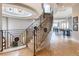 Grand marble staircase with wrought iron railing leads to the upper level at 8 Rue Mediterra Dr, Henderson, NV 89011