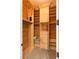 Custom walk-in closet with wood shelving, drawers, and ample storage space for clothing and accessories at 8 Rue Mediterra Dr, Henderson, NV 89011