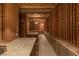 Spacious wine cellar with extensive custom wood racking, cabinets, and stone countertops for wine storage and display at 8 Rue Mediterra Dr, Henderson, NV 89011