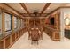 Elegant wine room with custom cabinetry, coffered ceilings, marble countertops, and a dining table for tastings at 8 Rue Mediterra Dr, Henderson, NV 89011