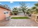 Landscaped backyard with artificial turf area, a patio, and mature trees for shade at 1925 Franklin Ave, Las Vegas, NV 89104
