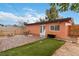 Charming backyard with a patio, seating area, and a small patch of artificial grass at 1925 Franklin Ave, Las Vegas, NV 89104