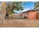 Wide backyard with mature trees, a rock bed, a lawn patch, and a patio at 1925 Franklin Ave, Las Vegas, NV 89104