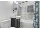 Updated bathroom with modern tiling around tub/shower and a sleek dark vanity at 1925 Franklin Ave, Las Vegas, NV 89104