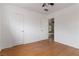 Clean bedroom with hardwood floors, white walls, a closet, and an open doorway at 1925 Franklin Ave, Las Vegas, NV 89104