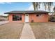 Charming single-story home with large windows, a front yard with gravel, and a walkway to the front door at 1925 Franklin Ave, Las Vegas, NV 89104