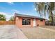 Charming single-story home with large windows, a manicured front yard, and a quaint gravel garden at 1925 Franklin Ave, Las Vegas, NV 89104