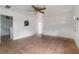 Bright living room featuring tiled floors, white walls, and ceiling fan, with open doorways at 1925 Franklin Ave, Las Vegas, NV 89104