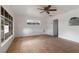Open living room featuring tiled floors, white walls, a ceiling fan, and bright natural lighting at 1925 Franklin Ave, Las Vegas, NV 89104