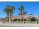Charming single-story home featuring lush palm trees, a brick-and-wrought-iron fence, and a well-manicured front yard at 485 Sari Dr, Las Vegas, NV 89110
