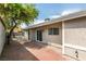 Backyard patio with brick and stucco exterior features mature shade tree at 6807 Sebring St, Las Vegas, NV 89103