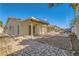 Spacious backyard with covered patio, stone pathway, and mature plants at 3189 Lipton Ct, Las Vegas, NV 89121