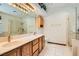 Elegant bathroom with dual sinks, large mirror, and walk-in shower at 3189 Lipton Ct, Las Vegas, NV 89121