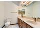 Double vanity bathroom with wood cabinets and large mirrors at 3189 Lipton Ct, Las Vegas, NV 89121