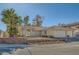 Single-story house with a three-car garage and desert landscaping at 3189 Lipton Ct, Las Vegas, NV 89121