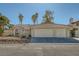 House exterior showcasing a three-car garage and Spanish-style roof at 3189 Lipton Ct, Las Vegas, NV 89121