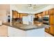 Kitchen with breakfast bar, oak cabinets, and granite counters at 3189 Lipton Ct, Las Vegas, NV 89121