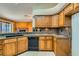 Kitchen boasts oak cabinets, granite countertops, and a black dishwasher at 3189 Lipton Ct, Las Vegas, NV 89121