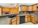 Kitchen with oak cabinets, granite countertops and a double sink at 3189 Lipton Ct, Las Vegas, NV 89121