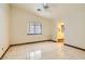 Large living room with tile floors and ceiling fan at 3189 Lipton Ct, Las Vegas, NV 89121