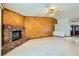 Bright living room features a brick fireplace and wood wall paneling at 3189 Lipton Ct, Las Vegas, NV 89121