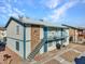 Two-story multi-Gathering home with blue trim, rock facade, and a balcony overlooking the front yard at 4740 Corsaire Ave, Las Vegas, NV 89115