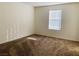 Well-lit bedroom with neutral carpeting and a large window at 5179 Silica Chalk Ave, Las Vegas, NV 89115